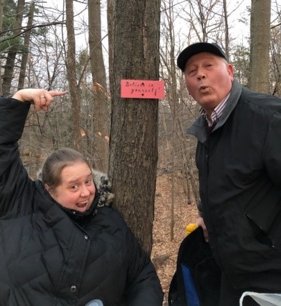 Kathryn and her dad pointing at a sign